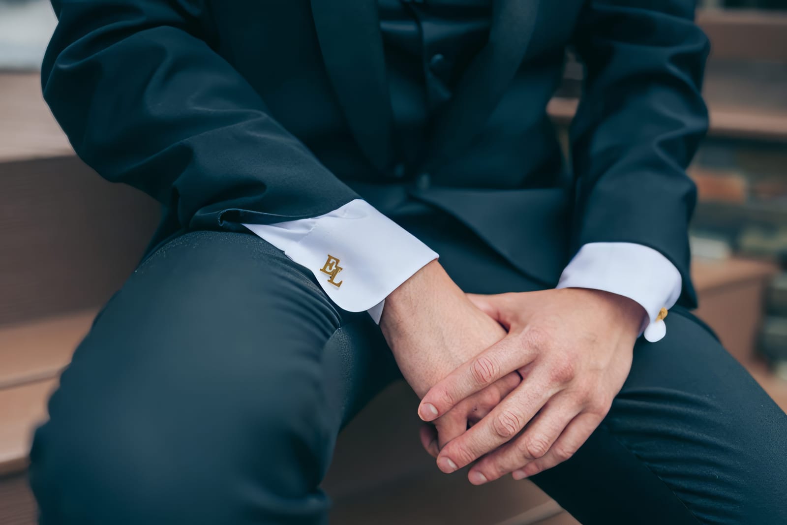 Close-up of monogrammed cufflinks reading E.L.