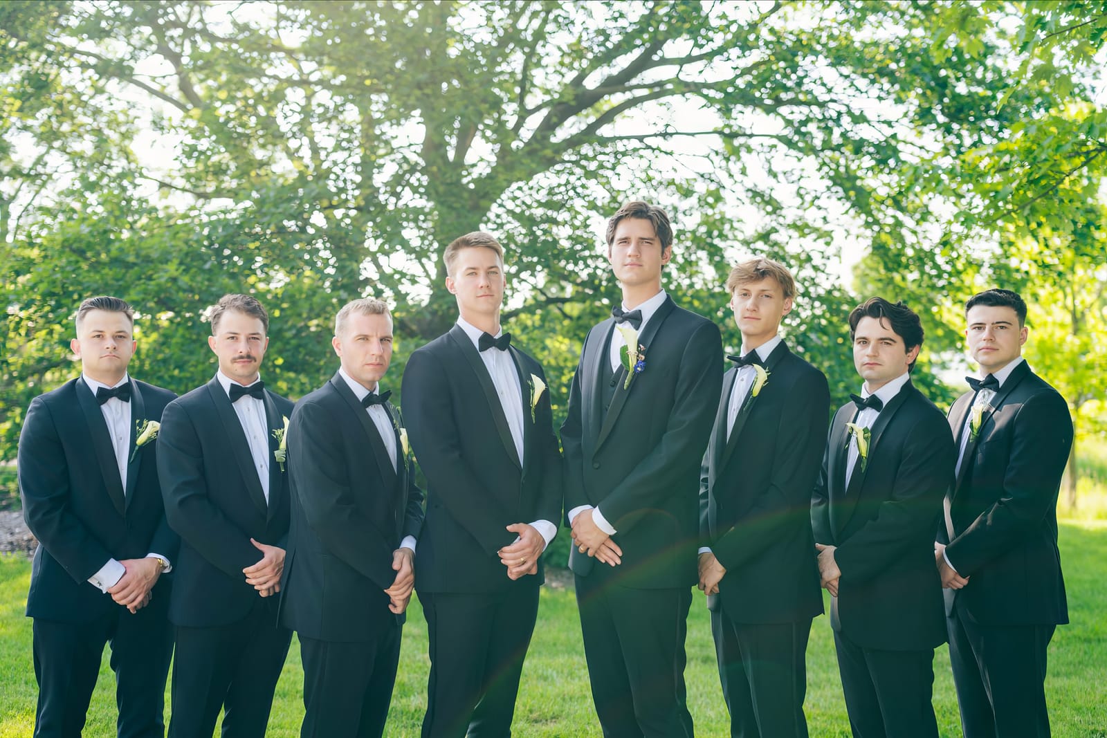 Eric standing with his groomsmen outdoors
